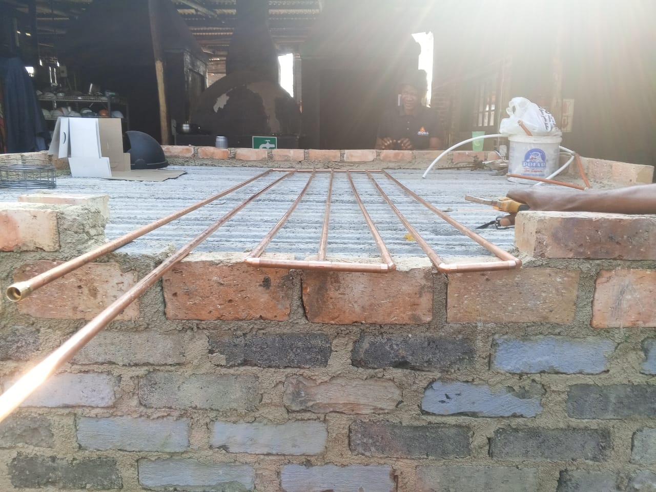 Copper piping measured across a brickwork base